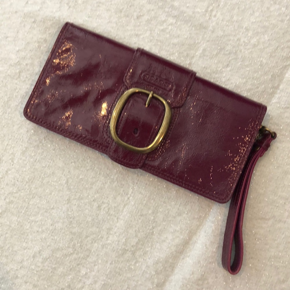 Deep pink/burgundy coach wristlet.